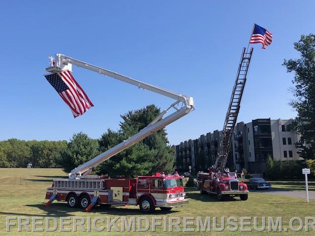 "Tiny" a snorkel owned by Bob Dinsmore and former Truck 16 now owned by Chief Kyd Dieterich fly "Old Glory" at the entrance to the show