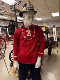 The "drivers helmet" used by long time driver Charles "Moose" Miller adorns the display of a wool United parade uniform. 